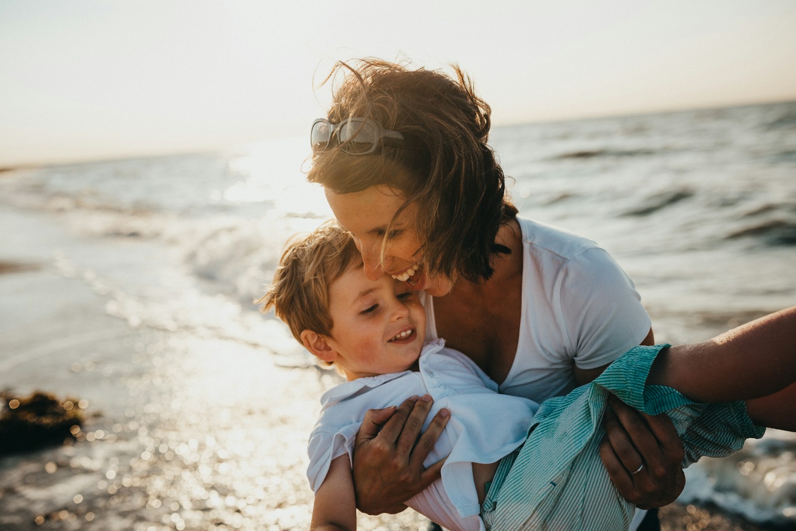 life, photo of mother and child beside body of water